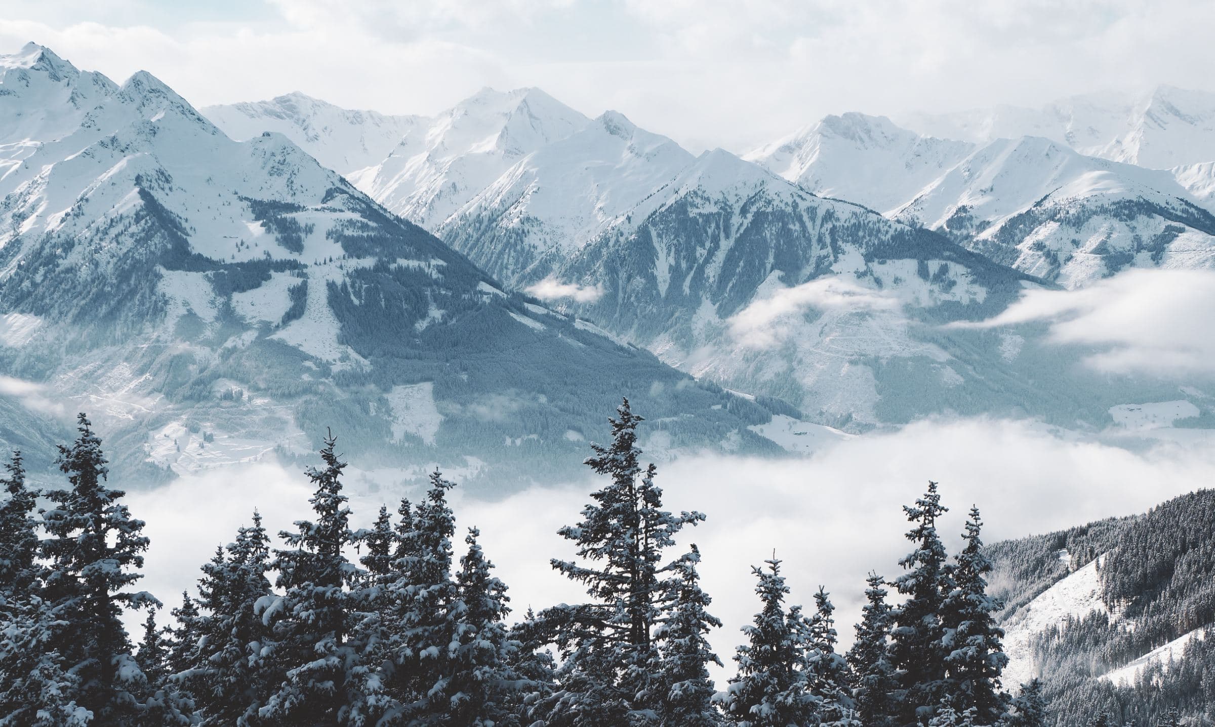 Snowbound Wasatch peaks above a fog-filled valley